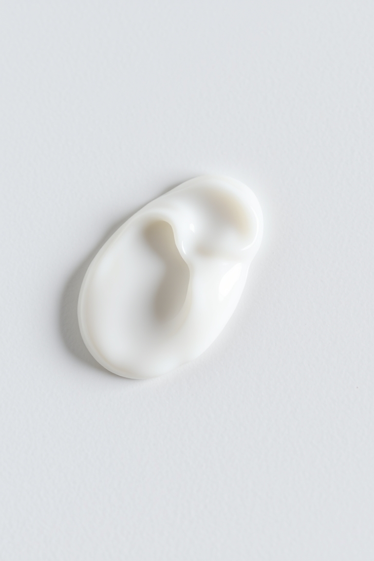 Applying a moisturizer for a gentle retinol routine.